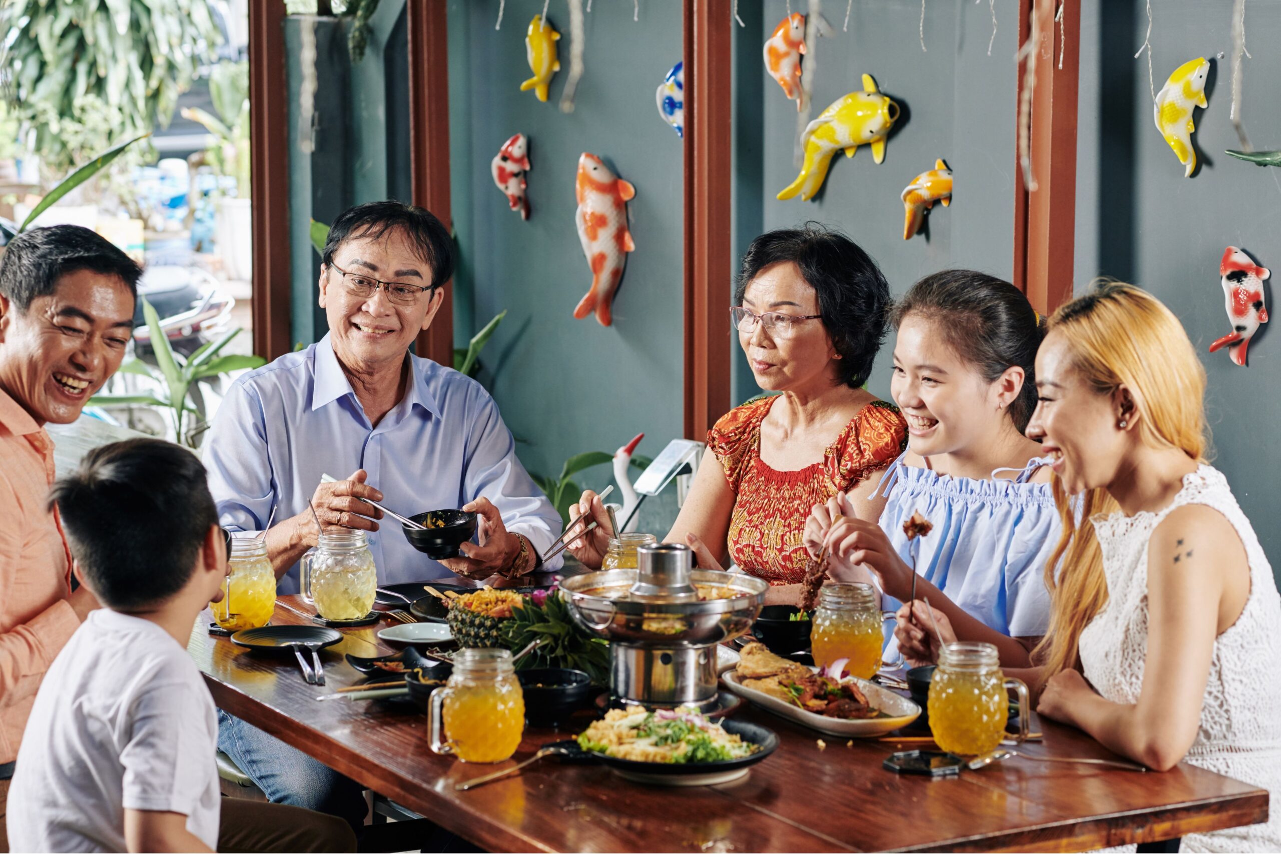 Salo-Salo communal dining tradition with Filipino family sharing meals around festive table