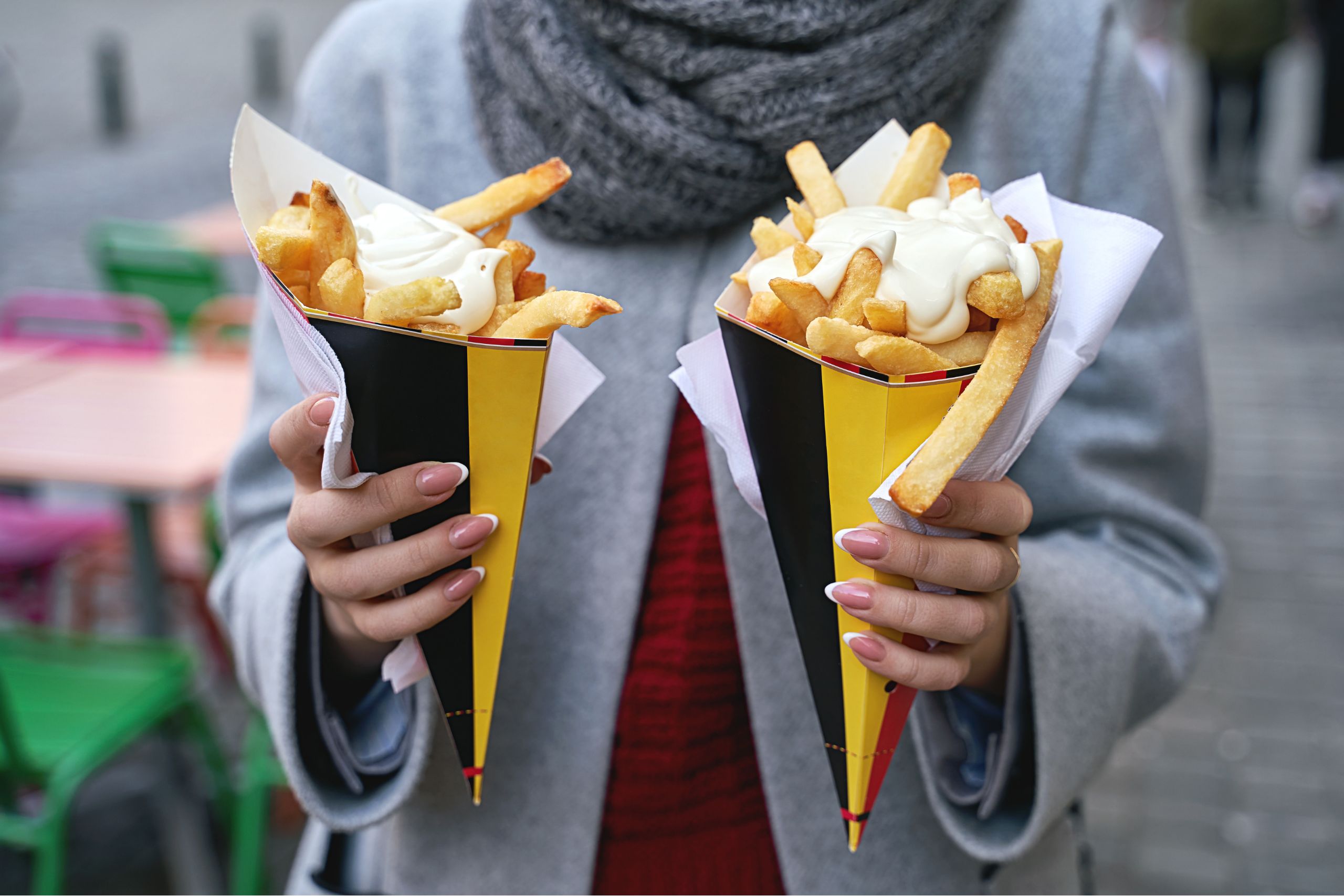 young lady with 2 cones belgian fries with mayonaise gusto webzine