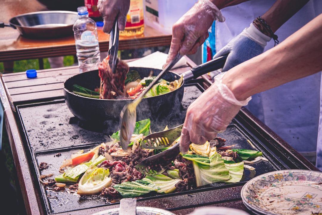 A chef carefully monitoring grill vegetables over high heat to achieve a smoky, charred finish