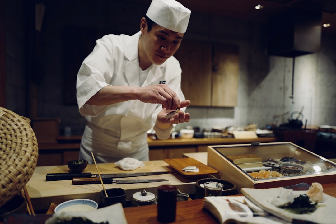 professional chef spreads miso paste onto a fillet in akitchen, showcasing miso as a versatile umami ingredient beyond soup.