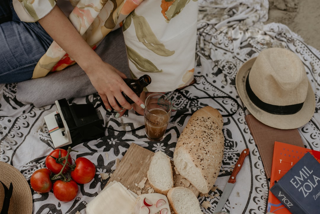 A woman arranges a traditional French picnic spread during a Bastille Day celebration outdoors