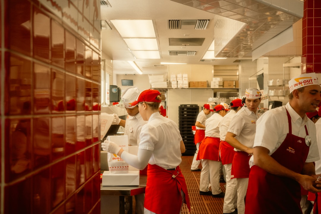 A hotel server guides a guest through an unfamiliar dish during staff training for global cuisines at a fine dining table
