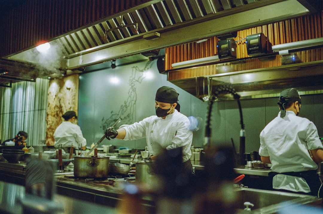 A head chef studies a new autumn menu at a prep counter, preparing for the seasonal shift from summer to cooler months