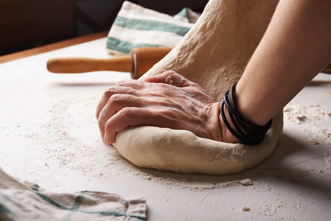 A skilled baker shaping a sourdough loaf by hand, reflecting the craft at the heart of global bread traditions