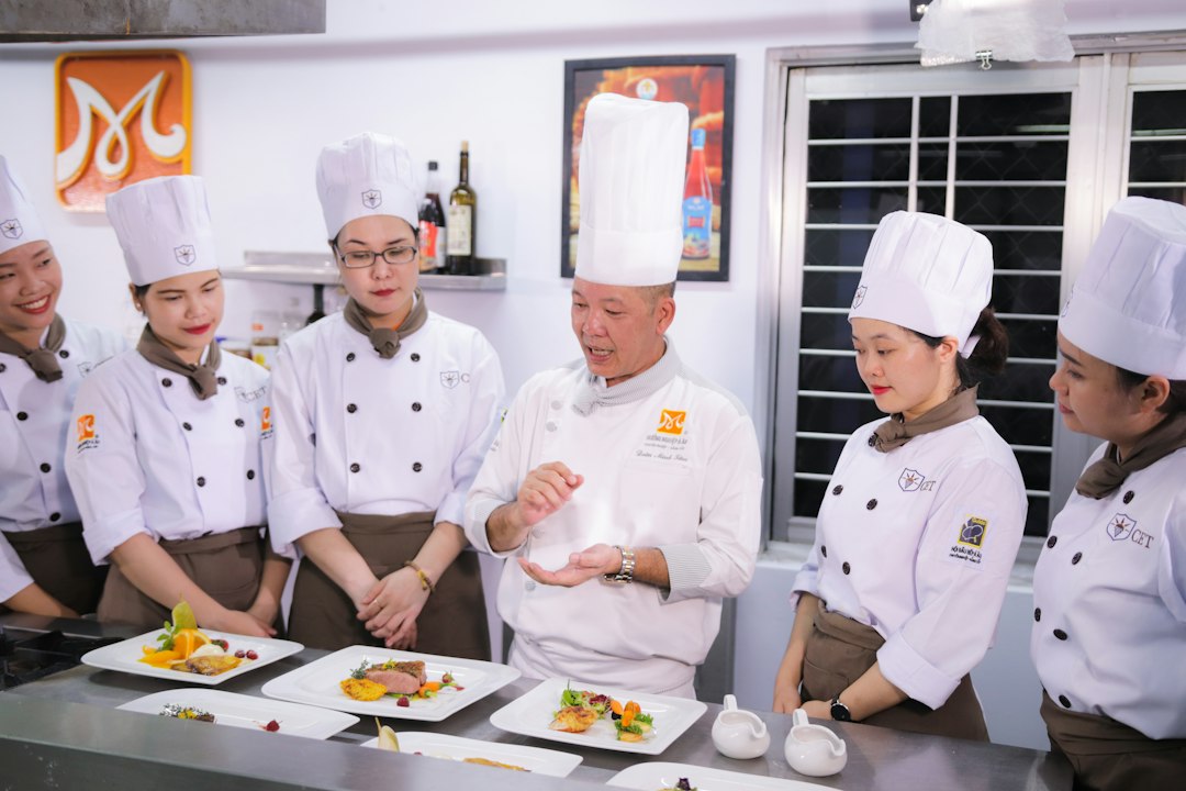 A chef presents a plate at an international culinary congress, like San Sebastian Gastronomika.