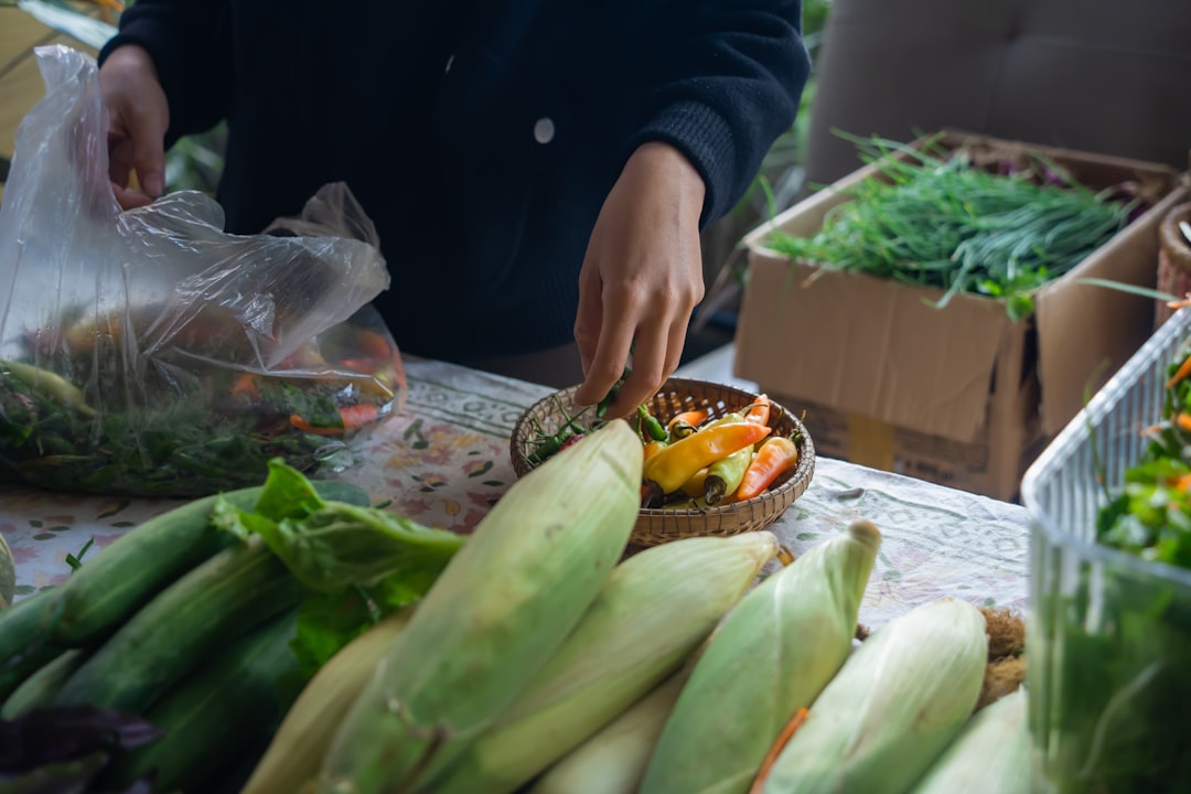 A hotel chef selects seasonal produce at a local market, reflecting the values of culturally grounded dining programmes