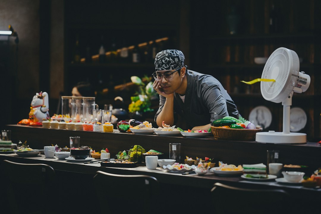 A hotel dining team member tastes a new dish during a pre-service training session, building ingredient knowledge.