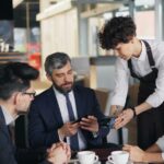 Restaurant manager briefing staff on new tipping rules